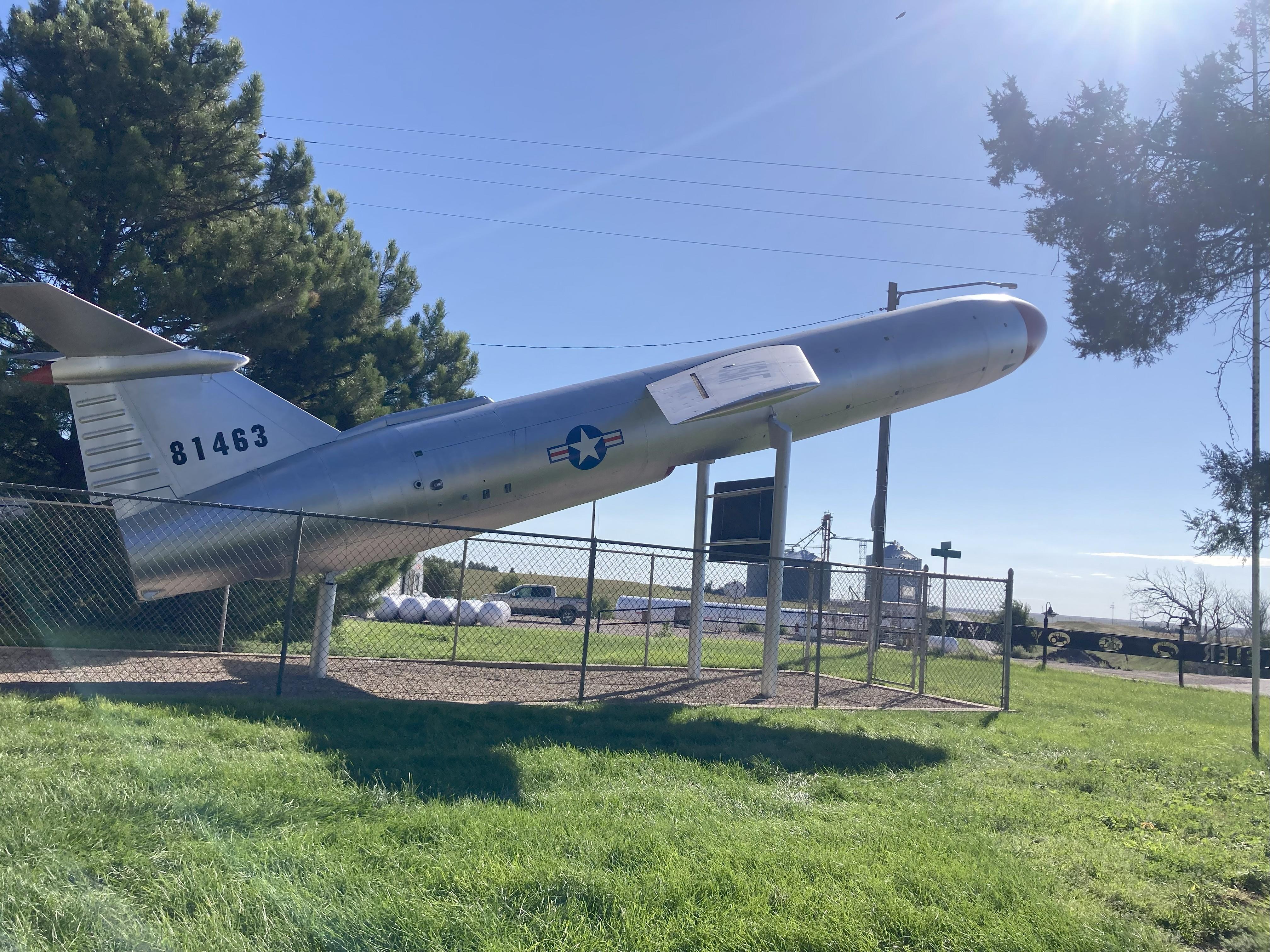 profile view of silver missile, red tip, white star emblem in circled in blue with red stripes, black tail numbers 81463