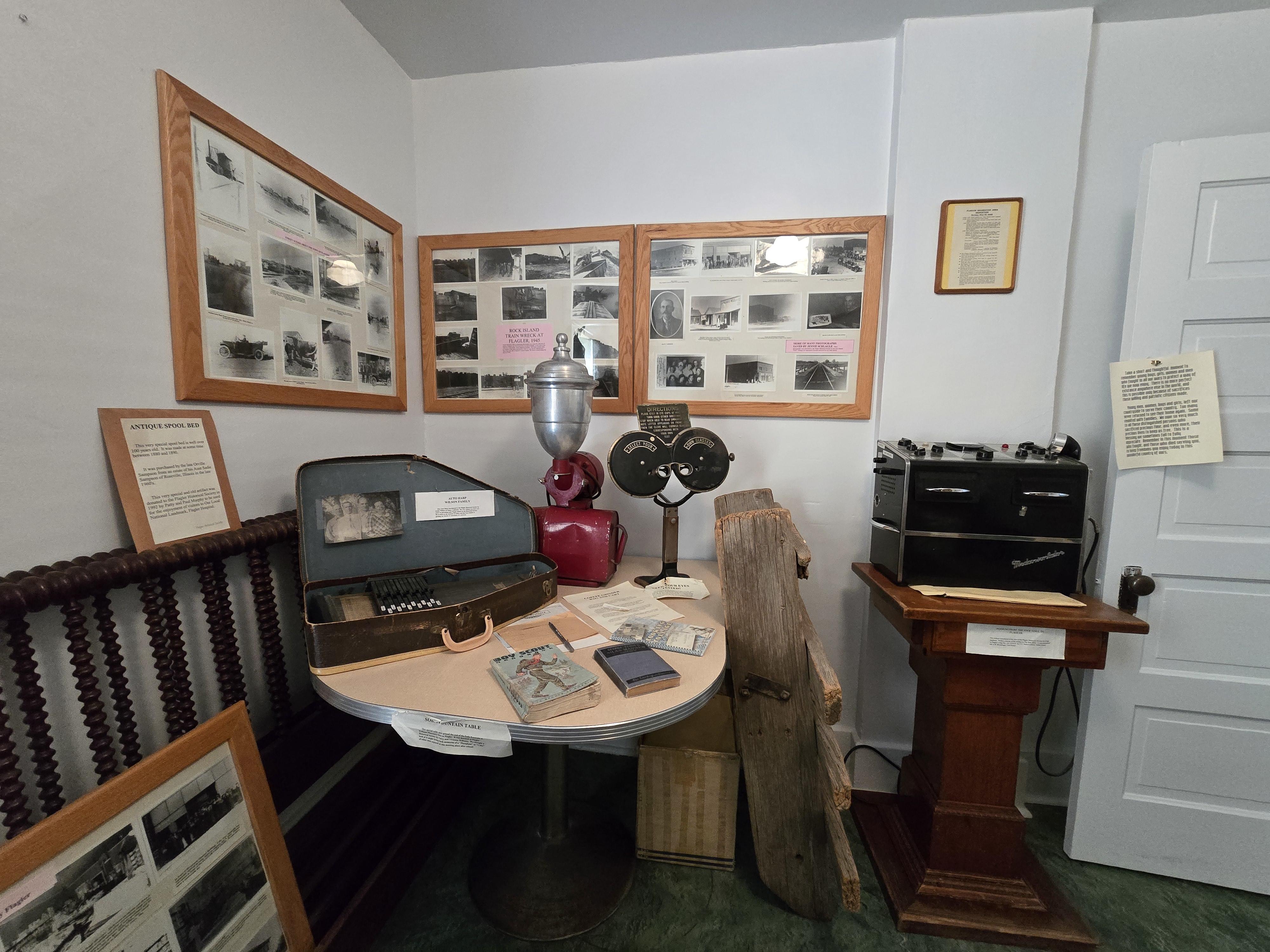 Black & white framed photos, black transmitter on a wooden table
